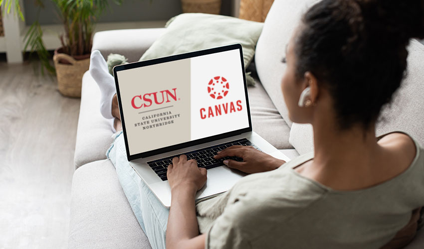 A woman typing on a laptop, with the Canvas logo visible, illustrating her involvement in digital learning